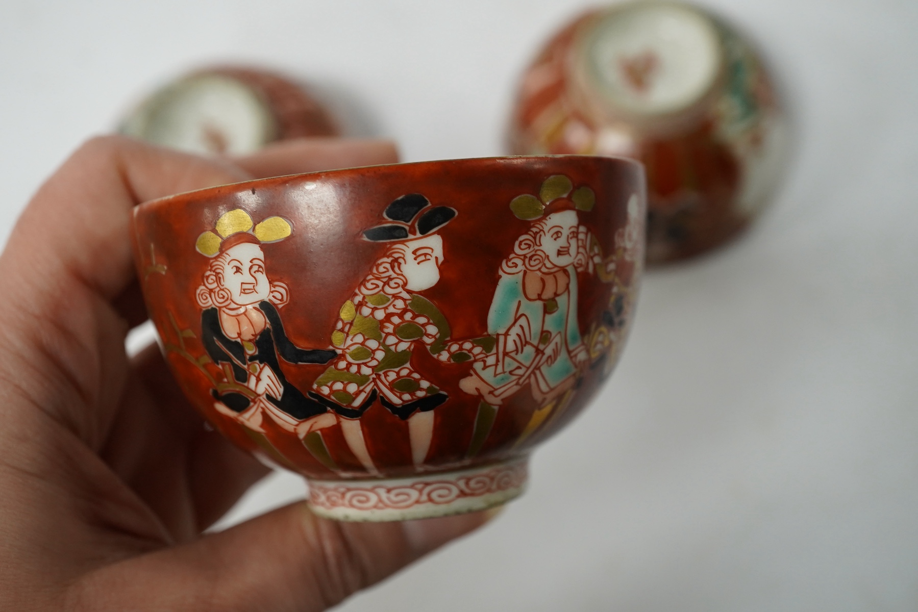 Three Imari ‘Black Ship’ teabowls, Meiji period, 8.5cm in diameter. Condition - good